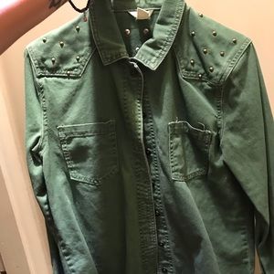 Army green denim jacket with spikes.